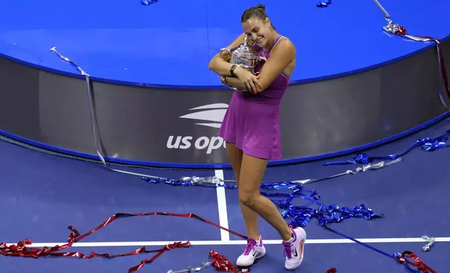 Aryna Sabalenka, of Belarus, hugs the trophy after winning the women's singles final of the U.S. Open tennis championships against Jessica Pegula, of the United States, Saturday, Sept. 7, 2024, in New York. (AP Photo/Kirsty Wigglesworth)