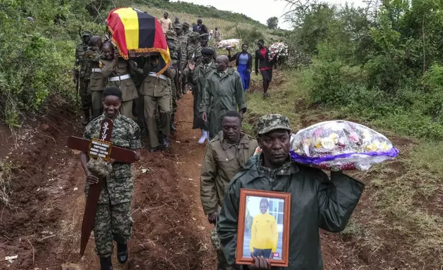 Members of the Uganda People's Defense Force carry the casket of Ugandan Olympic athlete Rebecca Cheptegei ahead of her burial in Kapkoros, Bukwo District, Uganda, on Saturday, Sept. 14. 2024. (AP Photo/Hajarah Nalwadda)