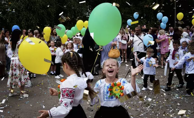 First-graders attend the traditional ceremony for the first day of school in Zaporizhzhia, Ukraine, Sunday Sept. 1, 2024. Zaporizhzhia schoolchildren celebrated the traditional first day of school near the frontline. (AP Photo/Evgeniy Maloletka)