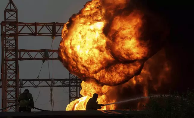 Rescue workers extinguish a fire of a burning electrical substation hit by a Russian bombing in Dnipropetrovsk region, Ukraine, Monday, Sept. 2, 2024. (AP Photo/Evgeniy Maloletka)