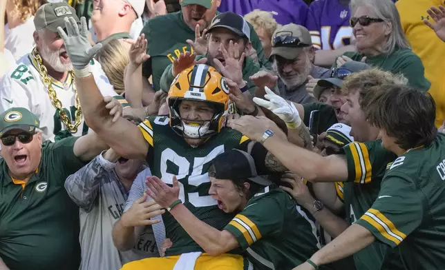 Green Bay Packers tight end Tucker Kraft (85) celebrates a touchdown with fans during the second half of an NFL football game against the Minnesota Vikings, Sunday, Sept. 29, 2024, in Green Bay, Wis. (AP Photo/Morry Gash)