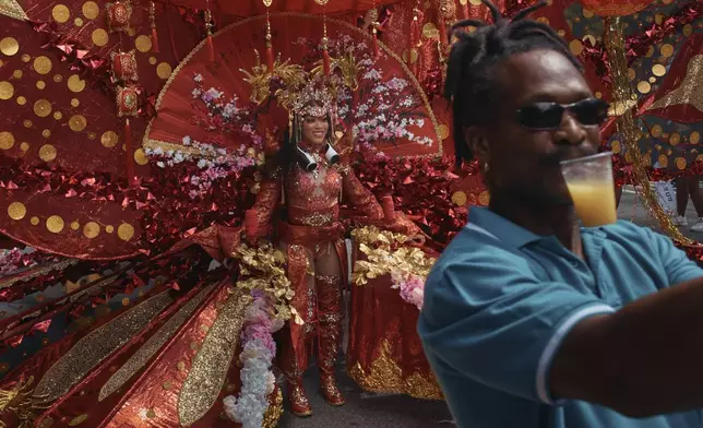 A man takes a selfie with a reveler during the West Indian Day Parade on Monday, Sept. 2, 2024, in the Brooklyn borough of New York. (AP Photo/Andres Kudacki)