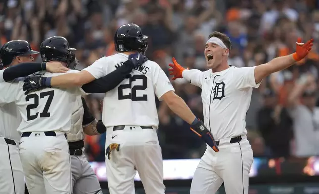 Detroit Tigers' Kerry Carpenter, right, celebrates his grand slam against the Chicago White Sox in the fifth inning of a baseball game, Sunday, Sept. 29, 2024, in Detroit. (AP Photo/Paul Sancya)