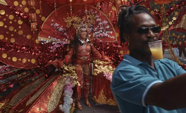 A man takes a selfie with a reveler during the West Indian Day Parade on Monday, Sept. 2, 2024, in the Brooklyn borough of New York. (AP Photo/Andres Kudacki)