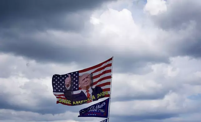 Flags showing support for Republican presidential nominee and former President Donald Trump fly near Trump's Mar-a-Lago estate in Palm Beach, Fla., Monday, Sept. 16, 2024. (AP Photo/Rebecca Blackwell)