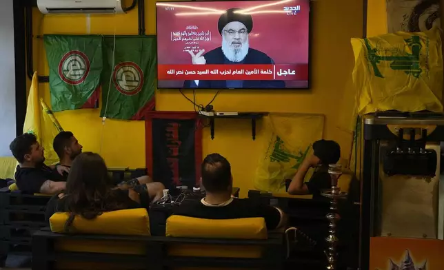 People watch the speech of Hezbollah leader Hassan Nasrallah as they sit in a cafe in the southern suburbs of Beirut, Thursday, Sept. 19, 2024. (AP Photo/Hassan Ammar)