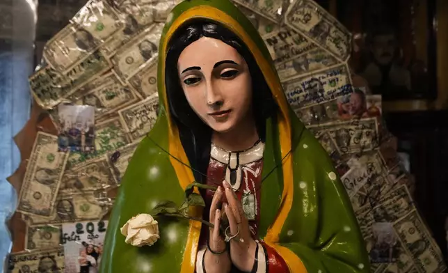 A statue of the Virgin of Guadalupe is displayed inside a shrine dedicated to Jesus Malverde, a folk saint viewed as the patron or protector of people involved in the drug trade, in Culiacan, Sinaloa state, Mexico, Friday, Sept. 20, 2024. (AP Photo/Eduardo Verdugo)