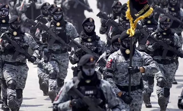 Mexican National Guards march in the Independence Day military parade through the capital's main square, the Zocalo, in Mexico City, Monday, Sept. 16, 2024. (AP Photo/Felix Marquez)