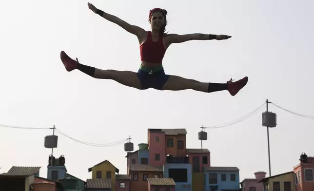 A Brazilian artist from the Ser Favela group performs on a stage with favela scenery at the Rock in Rio music festival in Rio de Janeiro, Brazil, Saturday, Sept. 14, 2024. (AP Photo/Bruna Prado)