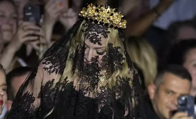 Madonna stands at the end of the Dolce &amp; Gabbana Spring Summer 2025 fashion show, that was presented in Milan, Italy, Saturday, Sept. 21, 2024. (AP Photo/Antonio Calanni)