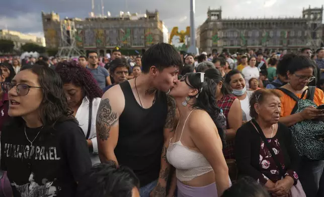 Alan Castaneda kisses his girlfriend Ingrid Flores prior an exhibition in memory of late Mexican pop star Juan Gabriel at the Zocalo, Mexico City's main square, Sunday, Sept. 22, 2024. (AP Photo/Fernando Llano)