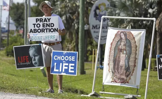 FILE - Dave Behrle, 70, of Safety Harbor holds a sign while standing outside the All Women's Health Center of Clearwater on May 3, 2022. (Chris Urso/Tampa Bay Times via AP, file)