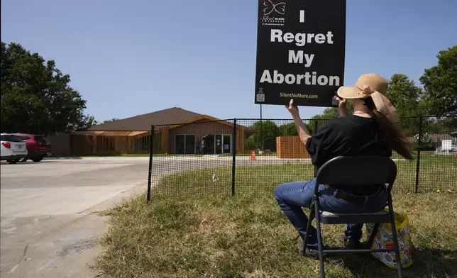 Anti-abortion protester Deborah Green-Myers, from Pittsburg, Kan., demonstrates outside a recently opened Planned Parenthood clinic, Tuesday, Sept. 10, 2024, in Pittsburg, Kan. (AP Photo/Charlie Riedel)