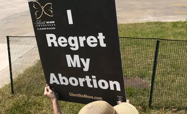 Anti-abortion protester Deborah Green-Myers, from Pittsburg, Kan., demonstrates outside a recently opened Planned Parenthood clinic, Tuesday, Sept. 10, 2024, in Pittsburg, Kan. (AP Photo/Charlie Riedel)