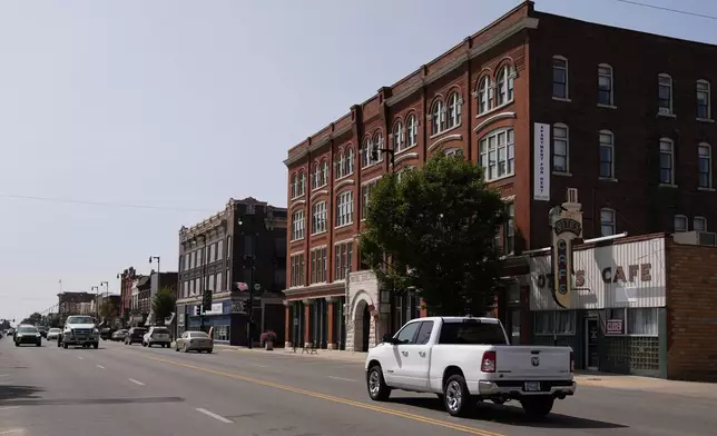 People drive through downtown Pittsburg, Kan., Tuesday, Sept. 10, 2024, that is home to a new Planned Parenthood clinic serving patients from Kansas as well as nearby Missouri, Oklahoma, Arkansas, Texas, and other states where abortions have become illegal or hard to get. (AP Photo/Charlie Riedel)