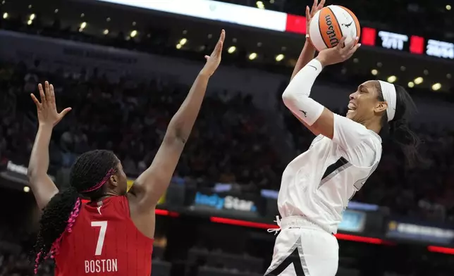 Las Vegas Aces' A'ja Wilson shoots over Indiana Fever's Aliyah Boston (7) during the second half of a WNBA basketball game, Wednesday, Sept. 11, 2024, in Indianapolis. (AP Photo/Darron Cummings)