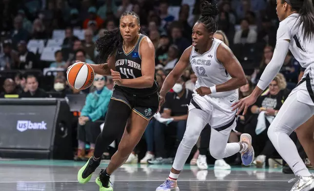 New York Liberty forward Betnijah Laney-Hamilton (44) is defended by Las Vegas Aces guard Chelsea Gray (12) during the first half of a WNBA basketball second-round playoff game, Sunday, Sept. 29, 2024, in New York. (AP Photo/Corey Sipkin)