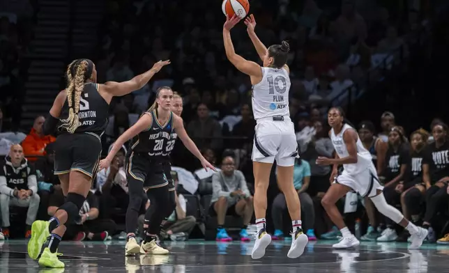 Las Vegas Aces guard Kelsey Plum (10) shoots a 3 point basket during the first half of a WNBA basketball second-round playoff game against the New York Liberty, Sunday, Sept. 29, 2024, in New York. (AP Photo/Corey Sipkin)