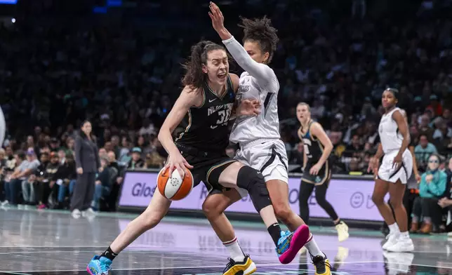 New York Liberty forward Breanna Stewart (30) is defended by Las Vegas Aces forward Alysha Clark (7) during the first half of a WNBA basketball second-round playoff game, Sunday, Sept. 29, 2024, in New York. (AP Photo/Corey Sipkin)