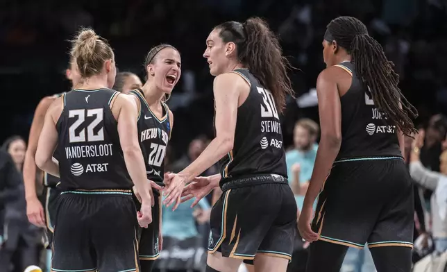 New York Liberty guard Sabrina Ionescu (20) celebrates with forward Breanna Stewart (30) during the second half of a WNBA basketball second-round playoff game against the Las Vegas Aces, Sunday, Sept. 29, 2024, in New York. (AP Photo/Corey Sipkin)