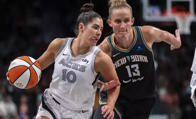 Las Vegas Aces guard Kelsey Plum (10) drives past New York Liberty forward Leonie Fiebich (13) during the second half of a WNBA basketball second-round playoff game, Sunday, Sept. 29, 2024, in New York. (AP Photo/Corey Sipkin)