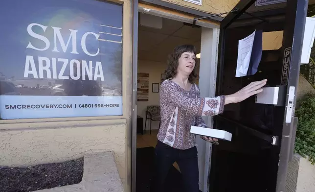 Methadone patient Irene Garnett, 44, of Phoenix, leaves a clinic after taking her medication in Scottsdale, Ariz., on Monday, Aug. 26, 2024. (AP Photo/Ross D. Franklin)