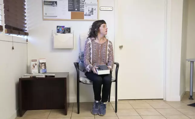 Methadone patient Irene Garnett, 44, of Phoenix, sits in the waiting room of a clinic in Scottsdale, Ariz., on Monday, Aug. 26, 2024. (AP Photo/Ross D. Franklin)