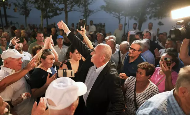 Fredis Beleris, a former ethnic Greek mayor of an Albanian town whose imprisonment on vote-buying charges has strained Albanian-Greek ties, gestures to supporters after his release on probation, in Himara, southwestern Albania, Monday, Sept. 2, 2024. (AP Photo/Vlasov Sulaj)