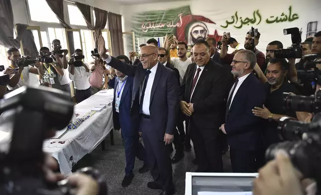 Presidential candidate of the Movement of Society for Peace (MSP), Abdelali Hassani Cherif, prepares to cast his ballot inside a polling station during the presidential election, Saturday, Sept. 7, 2024, in Algiers, Algeria. (AP Photo/Fateh Guidoum)