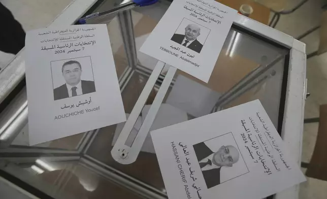 Ballots showing the three presidential candidates are placed on a table inside a polling station during the presidential election, Saturday, Sept. 7, 2024, in Algiers, Algeria. (AP Photo/Anis Belghoul)