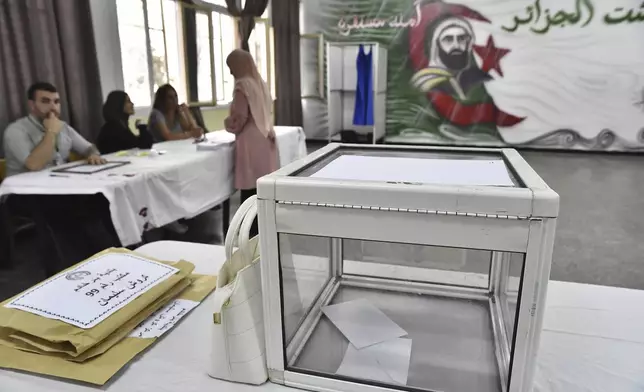 Election officials wait for voters inside a polling station during the presidential election, Saturday, Sept. 7, 2024, in Algiers, Algeria. (AP Photo/Fateh Guidoum)