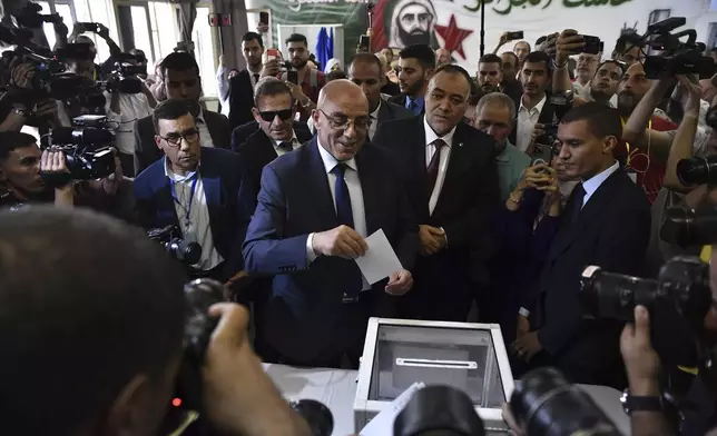 Presidential candidate of the Movement of Society for Peace (MSP), Abdelali Hassani Cherif, prepares to cast his ballot inside a polling station during the presidential election, Saturday, Sept. 7, 2024, in Algiers, Algeria. (AP Photo/Fateh Guidoum)