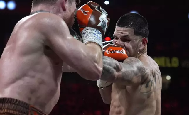 Canelo Alvarez hits Edgar Berlanga in a super middleweight title bout Saturday, Sept. 14, 2024, in Las Vegas. (AP Photo/John Locher)