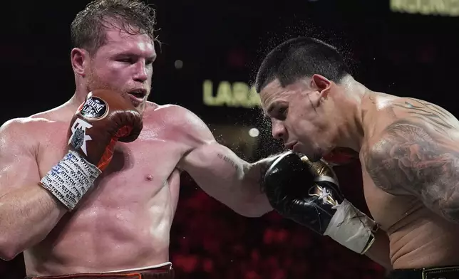 Canelo Alvarez hits Edgar Berlanga in a super middleweight title bout Saturday, Sept. 14, 2024, in Las Vegas. (AP Photo/John Locher)