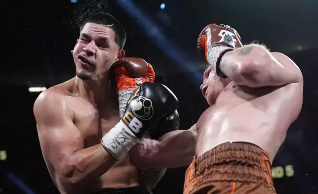 Canelo Alvarez hits Edgar Berlanga in a super middleweight title bout Saturday, Sept. 14, 2024, in Las Vegas. (AP Photo/John Locher)