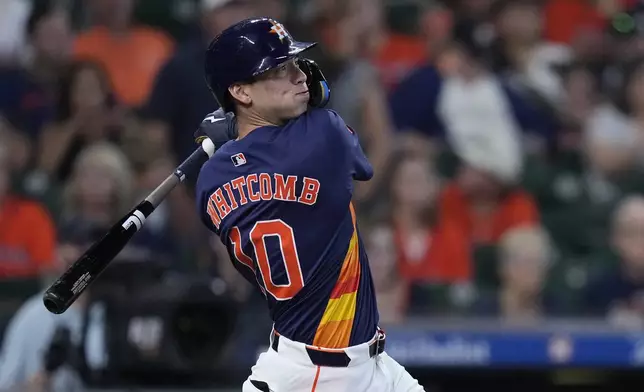 Houston Astros pinch hitter Shay Whitcomb hits a go-ahead RBI single during the eighth inning of a baseball game against the Los Angeles Angels, Sunday, Sept. 22, 2024, in Houston. (AP Photo/Kevin M. Cox)