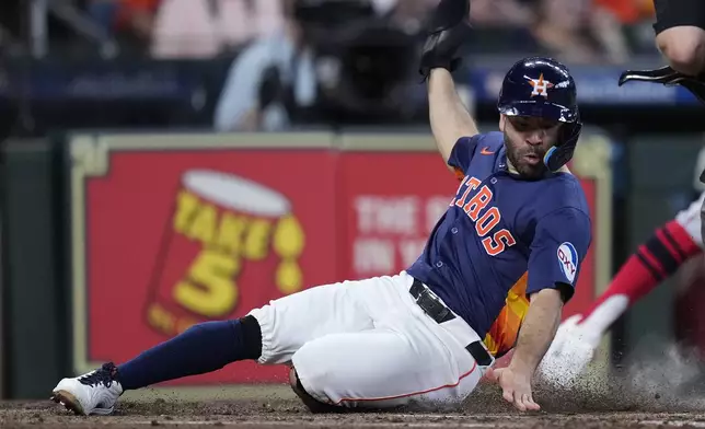 Houston Astros' Jose Altuve scores on a sacrifice fly during the third inning of a baseball game against the Los Angeles Angels, Sunday, Sept. 22, 2024, in Houston. (AP Photo/Kevin M. Cox)