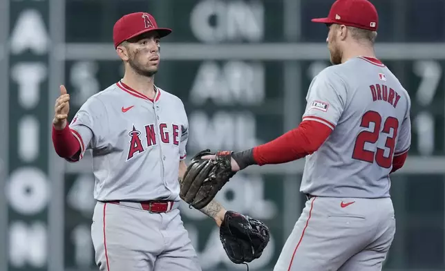 Los Angeles Angels shortstop Zach Neto, left, and first baseman Brandon Drury (23) celebrate after a baseball game against the Houston Astros, Sunday, Sept. 22, 2024, in Houston. (AP Photo/Kevin M. Cox)