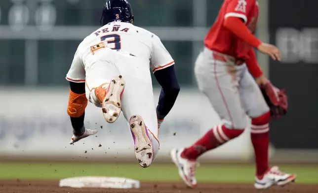 Houston Astros' Jeremy Pena slides into second for a double against the Los Angeles Angels during the fourth inning of a baseball game, Saturday, Sept. 21, 2024, in Houston. (AP Photo/Eric Christian Smith)