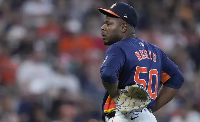 Houston Astros relief pitcher Héctor Neris reacts after giving up a run on a balk during the seventh inning of a baseball game against the Los Angeles Angels, Sunday, Sept. 22, 2024, in Houston. (AP Photo/Kevin M. Cox)