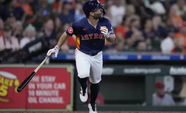 Houston Astros' Jose Altuve tosses his bat after hitting a solo home run during the fifth inning of a baseball game against the Los Angeles Angels, Sunday, Sept. 22, 2024, in Houston. (AP Photo/Kevin M. Cox)