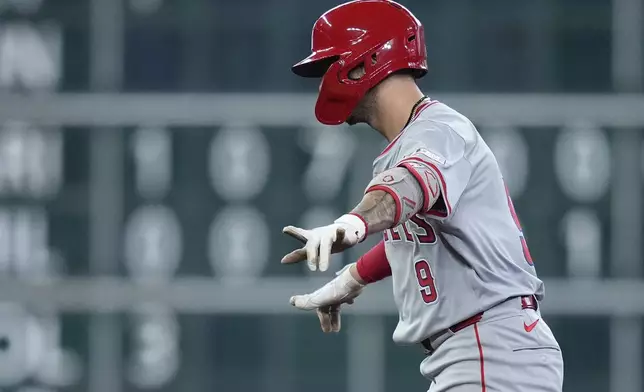 Los Angeles Angels' Zach Neto celebrates after hitting a three-run double during the ninth inning of a baseball game against the Houston Astros, Sunday, Sept. 22, 2024, in Houston. (AP Photo/Kevin M. Cox)