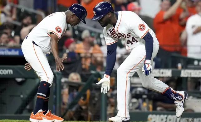 Houston Astros designated hitter Yordan Alvarez, right, celebrates his solo home run against the Los Angeles Angels with third base coach Gary Pettis during the seventh inning of a baseball game, Saturday, Sept. 21, 2024, in Houston. (AP Photo/Eric Christian Smith)