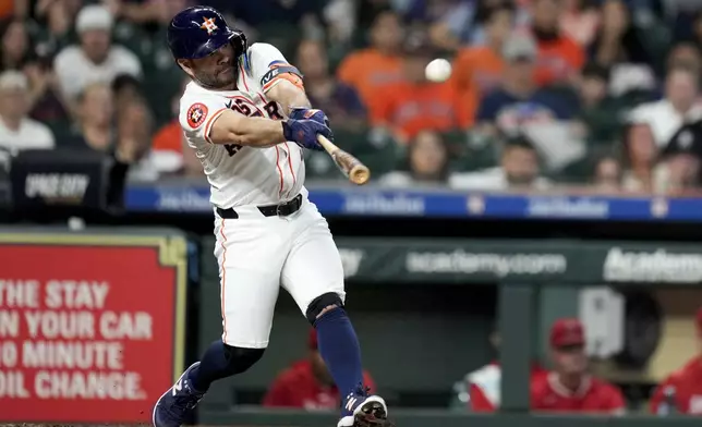 Houston Astros' Jose Altuve hits an RBI single against the Los Angeles Angels during the second inning of a baseball game, Saturday, Sept. 21, 2024, in Houston. (AP Photo/Eric Christian Smith)