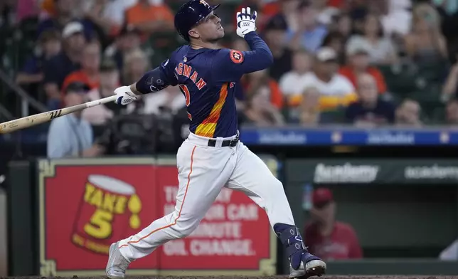 Houston Astros' Alex Bregman hits an RBI sacrifice fly during the third inning of a baseball game against the Los Angeles Angels, Sunday, Sept. 22, 2024, in Houston. (AP Photo/Kevin M. Cox)