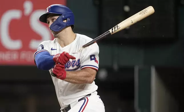 Texas Rangers' Wyatt Langford follows through on a broken-bat single in the fifth inning of a baseball game against the Los Angeles Angels Thursday, Sept. 5, 2024, in Arlington, Texas. (AP Photo/Tony Gutierrez)