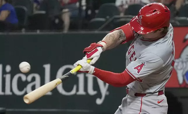 Los Angeles Angels' Mickey Moniak breaks his bat as he hits a single that scored teammate Nolan Schanuel during the sixth inning of a baseball game against the Texas Rangers, Saturday, Sept. 7, 2024, in Arlington, Texas. (AP Photo/LM Otero)