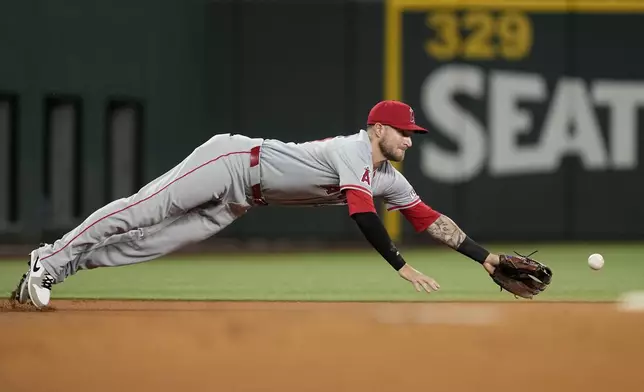 Los Angeles Angels third baseman Charles Leblanc is unable to reach a single hit by Texas Rangers' Marcus Semien in the first inning of a baseball game Thursday, Sept. 5, 2024, in Arlington, Texas. (AP Photo/Tony Gutierrez)