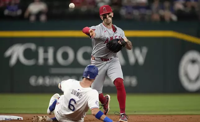 Los Angeles Angels second baseman Michael Stefanic throws to first to complete the double play on Jonah Heim after forcing out Texas Rangers' Josh Jung (6) at second in the first inning of a baseball game Thursday, Sept. 5, 2024, in Arlington, Texas. (AP Photo/Tony Gutierrez)