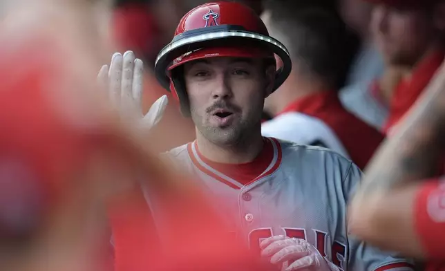 Los Angeles Angels' Nolan Schanuel celebrates in the dugout after hitting a solo home run during the third inning of a baseball game against the Minnesota Twins, Wednesday, Sept. 11, 2024, in Minneapolis. (AP Photo/Abbie Parr)